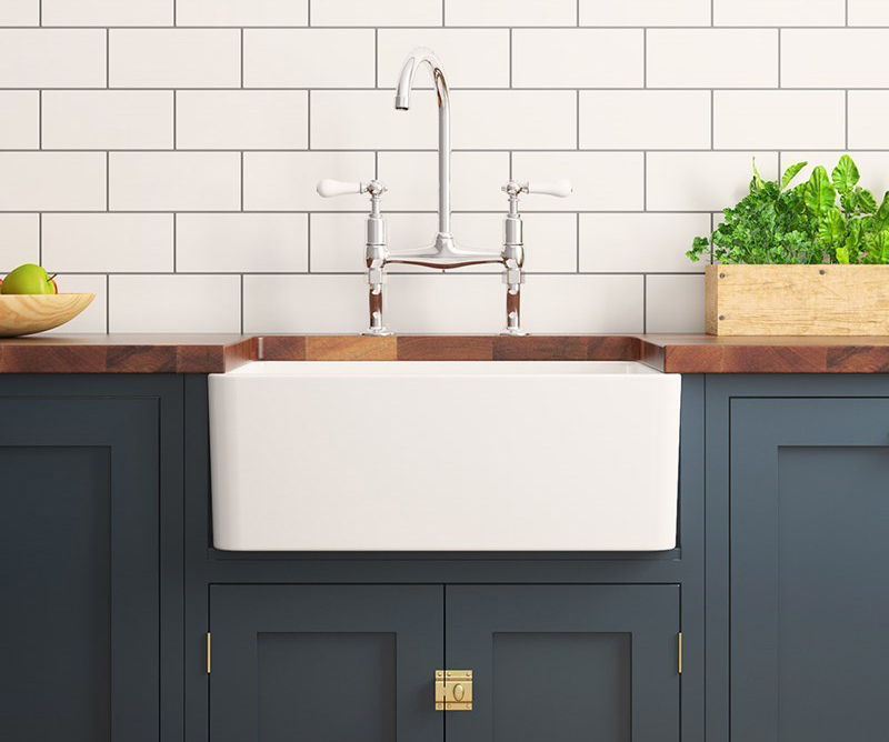 Ceramic Belfast sink on blue wooden kitchen cabinet with kitchen bridge mixer