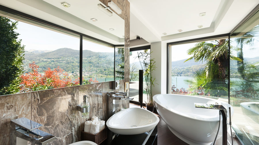 bathroom featuring a lot of glass which is ideal for a glass waterfall basin mixer
